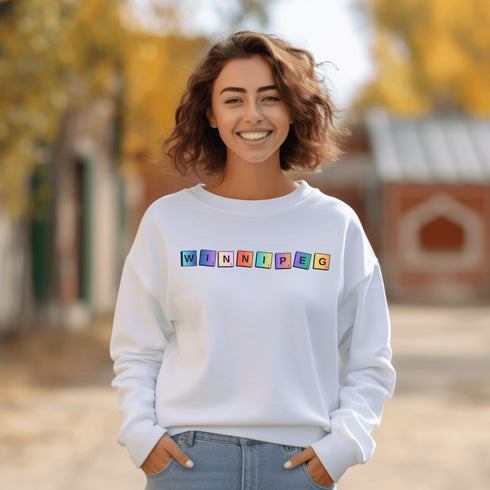 Introducing our newest addition to your wardrobe - the trendy graphic sweatshirt featuring colorful Winnipeg Scrabble Titles.